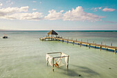 Aerial view of man relaxing on a hammock along the beach of Villa Isabela, Puerto Plata, Dominican Republic.