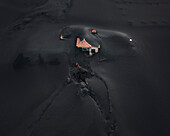 Aerial view of a building covered with ashes from Cumbre Vieja volcano in La Palma island, Canary Islands, Spain.