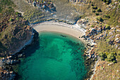 Aerial view of pristine sandy beach and rocky cliffs along the serene coastline, Middle Island, Dampier Peninsula, Kimberley Region, Australia.