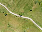 Aerial view of white car on asphalt road in the countryside, Greece