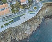 Aerial view of beautiful coastline and promenade with seaside shops and residential buildings, Baiona, Spain.