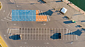 Aerial view of colorful parking area with organized lines and vehicles, Varna, Bulgaria.