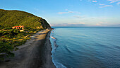 Aerial view of coastal jungle and tropics with ocean, hills, and house, Santa Marta, Colombia.