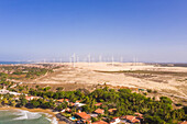 Aerial view of the beach shore with windmills in the background, Taiba, São Gonçalo do Amarante, Ceará, Brazil