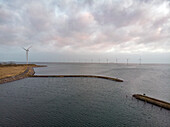 Aerial view of Wind turbines Located On Water In Cloudy Weather In Copenhagen, Denmark.