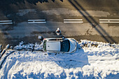 Drone selfie on the side of snowy road.