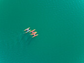 Aerial view of group of people having fun while riding water bikes at lake Plastira in Greece