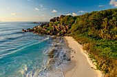 Aerial view of a person walking on the beach at Grand Anse, La Digue and Inner Islands, Seychelles.