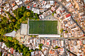 Aerial view of a small football stadium in a high dented population residential district in Medellin, Antioquia, Colombia.