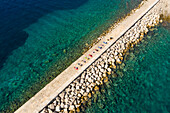 Aerial view of group practicing yoga at artificial pier, Veli Lošinj, Croatia.