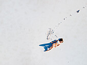 Aerial view of woman in white swimsuit on white beach, Cape Town, South Africa.