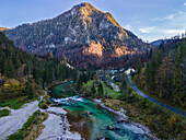 Aerial drone view of Salza River with a mountain peak in the background on a fall day under a clear sky surrounded by a forest, Wildalpen, Austria.