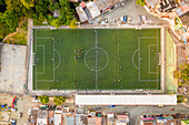 Aerial view of a small football stadium in a high dented population residential district in Medellin, Antioquia, Colombia.