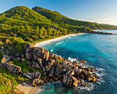 Aerial view of a paradise beach with granite formation along the shore near Grand Anse Bay, La Digue and Inner Islands, Seychelles.