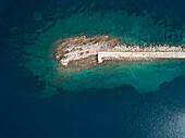 Aerial view of artificial rock pier at transparent water, Veli Lošinj, Croatia.