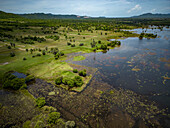 Aerial view of the Secret lake surrounded by green nature in Kampot province, Cambodia.