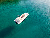 Aerial view of single speed boat floating over transparent water, Croatia.