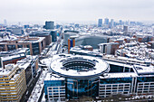 Brussels, Belgium - 8 February 2021: Aerial view of a European Union building under the snow at wintertime near Parque du Cinquantenaire.