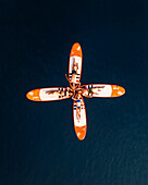 Aerial view of girls surfing with a red surfboard in the blue ocean, Primorje-Gorski Kotar, Croatia.