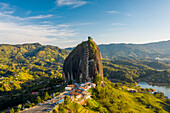 Aerial view of Piedra del Penol touristic attraction, a huge rock with steps to the top near Guatapé town, Antioquia, Colombia.