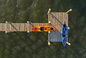 Aerial view of a few canoe standing on a wooden pier along River Lagoon, Sebastian, Florida, United States.