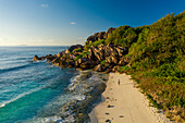 Aerial view of a person walking on the beach at Grand Anse, La Digue and Inner Islands, Seychelles.