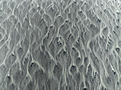 Aerial view of abstract patterns in a glacier river, Kalfafell, Iceland.