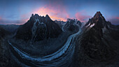 Aerial view of the majestic Mer de Glace glacier surrounded by rugged mountains and a tranquil valley, La Tour Argentiere Les Praz, France.