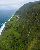 Aerial view of Cascata do Poco do Bacalhau, a beautiful waterfall in Faja Grande, Azores islands, Portugal.