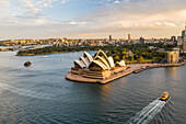 Aerial view of Sydney Opera House, a famous Australian landmark and public theatre in Sydney downtown at sunset, New South Wales, Australia.