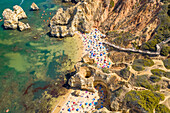 Aerial view of Praia do Camilo, hidden beach accessible by steep steps, Portugal.