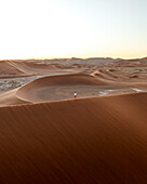 Aerial view of sand dunes and persons in Sossusvlei, Deadvlei, Namibia.