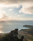 Aerial view of a person on top of Le Chat y La Souris mountain or Mount Villars, in the Bambous Range near Grand Sable, Flacq, Mauritius.