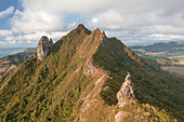 Aerial view of a person on top of Le Chat y La Souris mountain or Mount Villars, in the Bambous Range near Grand Sable, Flacq, Mauritius.