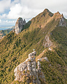 Aerial view of a person on top of Le Chat y La Souris mountain or Mount Villars, in the Bambous Range near Grand Sable, Flacq, Mauritius.