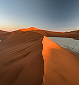 Aerial view of sandy Sossusvlei and Deadvlei with sand dunes, persons, Hardap, Namibia.