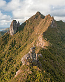 Aerial view of a person on top of Le Chat y La Souris mountain or Mount Villars, in the Bambous Range near Grand Sable, Flacq, Mauritius.