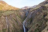 Aerial view of a small river streaming along the mountain on Unalaska island, Alaska, United States.