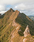 Aerial view of a person on top of Le Chat y La Souris mountain or Mount Villars, in the Bambous Range near Grand Sable, Flacq, Mauritius.