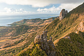 Aerial view of a person on top of Le Chat y La Souris mountain or Mount Villars, in the Bambous Range near Grand Sable, Flacq, Mauritius.