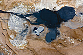 Aerial view of abstract patterns created by hotsprings and mudpots, in Hverir geothermal area in North Iceland.