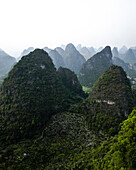 Aerial view of majestic karst mountains and lush green vegetation, Guilin, China.