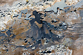 Aerial view of abstract patterns created by hotsprings and mudpots, in Hverir geothermal area in North Iceland.