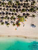 Aerial view of people under the parasol on Palm Beach along the Caribbean Sea in Aruba.