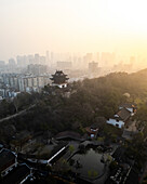 Aerial view of a beautiful urban skyline with modern buildings and traditional architecture amidst a serene park, Wuhan, China.