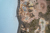 Aerial view of a coastline along the lakefront at Gunnuhver Hot Springs (Geo Thermal Hot Spring), Grindavík, Iceland.