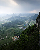 Aerial view of breathtaking karst mountains and lush greenery in a tranquil valley, Guilin, China.