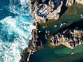 Aerial view of ilheus da janela with beautiful cliffs and crashing waves, Porto Moniz, Portugal.