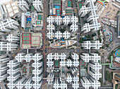 Aerial view of modern urban landscape with densely arranged skyscrapers and organized streets, Kowloon City, Hong Kong.