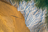 Aerial view of a person on the beach at Playa de los Amantes, Cabo San Lucas, Baja California, Mexico.